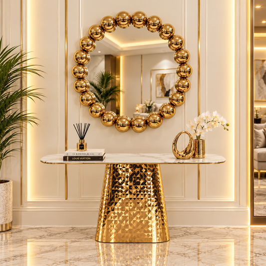Aurelia gold console styled beneath a sculptural gold mirror